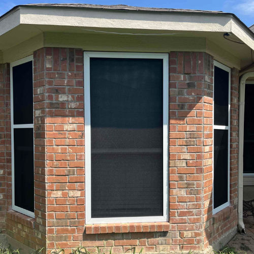 Den Defenders security window screens installed on residential windows for airflow and added protection